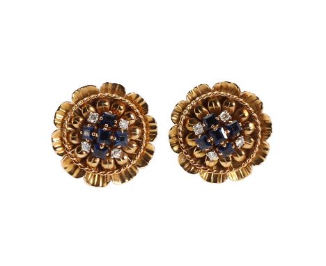 A pair of large flowerhead earrings, with sapphire and diamond centres, the central cluster of five calibré cut sapphires in 