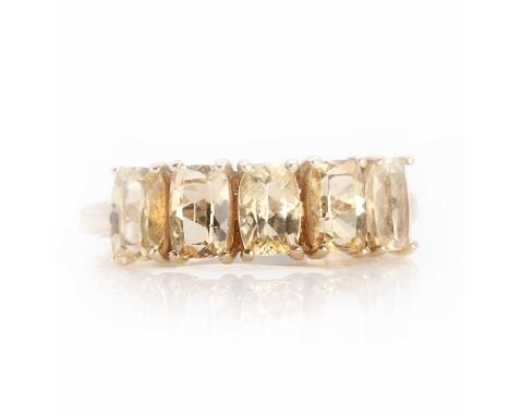 A 9ct gold five stone topaz ring, with five cushion cut topaz with a stated total gemstone weight of 2.82ct, all four claw se