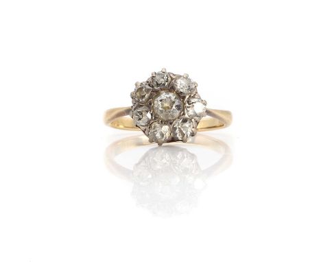 An early 20th century diamond daisy cluster ring,centring an old European diamond within a surround of smaller old cut diamon