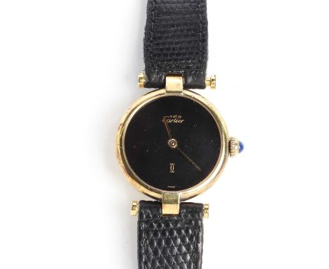 A ladies' silver gilt Must de Cartier quartz strap watch, c.1980,24mm diameter, with a black enamelled dial, gilt spade hands