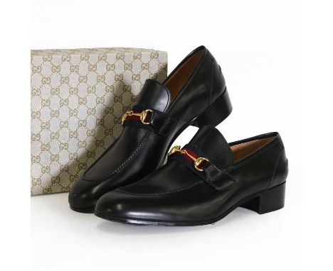 A pair of men's Gucci black leather loafers, with classic techno-coloured red and blue canvas strap and gold-tone horse bit d