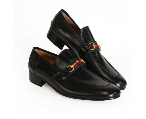 A pair of Gucci men's black leather loafers, with classic techno-coloured canvas strap and gold tone horse bit buckle, with l
