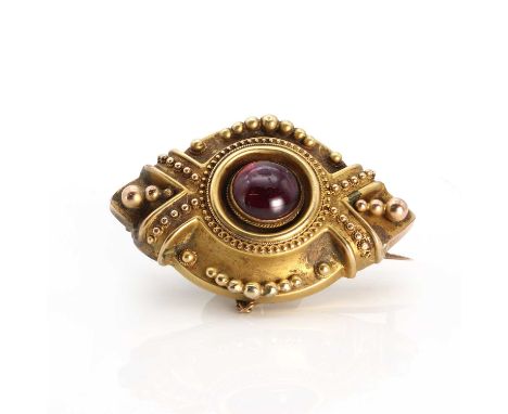 A Victorian garnet set shield form brooch of navette shape c.1890,  with a circular cabochon garnet rub set to the centre wit