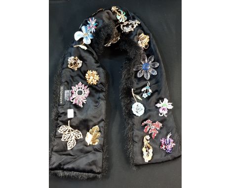 LARGE QUANTITY OF ENAMEL FLOWER BROOCHES ON FAUX FUR COLLAR