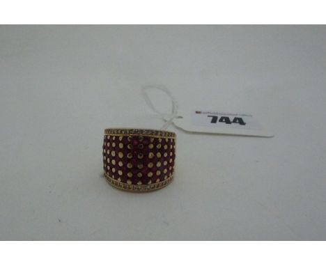 A Modern TJC Ruby Set Cocktail Dress Ring, gilt, stamped "925", of wide design, set throughout with circular cut rubies (fing