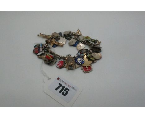 A Curb Link Charm Bracelet, suspending numerous souvenir enamel shield charm pendants, etc. 