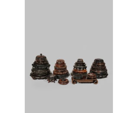 TWENTY CHINESE WOOD STANDS AND FIVE COVERS 19TH AND 20TH CENTURY One scroll-shaped with an apron inlaid with wire, one hexago