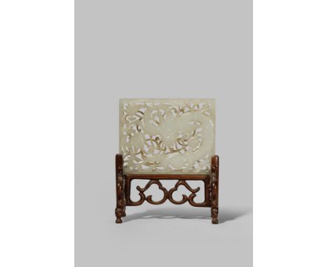 A CHINESE PALE CELADON JADE RECTANGULAR PLAQUE QING DYNASTY Finely carved with a reticulated dragon amongst stylised foliage 