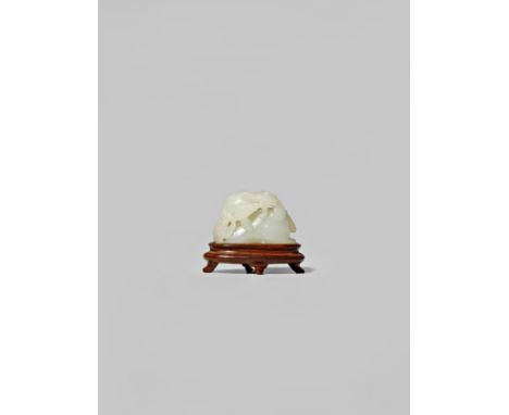 A CHINESE WHITE JADE CARVING OF A GOAT QING DYNASTY Recumbent with curved ribbed horns, holding a spray of lingzhi fungus in 