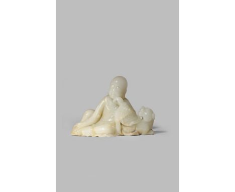 A CHINESE PALE CELADON JADE CARVING OF A LUOHAN QING DYNASTY Sitting in a contemplative pose, resting his arm on the back of 