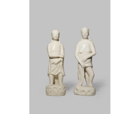 A RARE PAIR OF CHINESE BLANC DE CHINE ADAM AND EVE FIGURES 17TH CENTURY Each standing on a rocky plinth, their chests bare, e