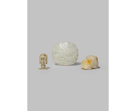 THREE CHINESE CELADON JADE CARVINGS QING DYNASTY One an oval plaque carved with a bat and a chrysanthemum, another of a lion 