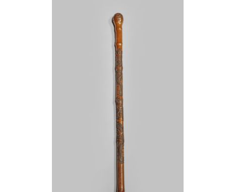 A JAPANESE BAMBOO WALKING STICK EARLY 20TH CENTURY The upper section carved with two scaly dragons, a six character signature