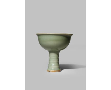 A CHINESE LONGQUAN CELADON STEM CUP SONG/YUAN DYNASTY The plain U-shaped body with an everted rim, raised on a tall flared ri