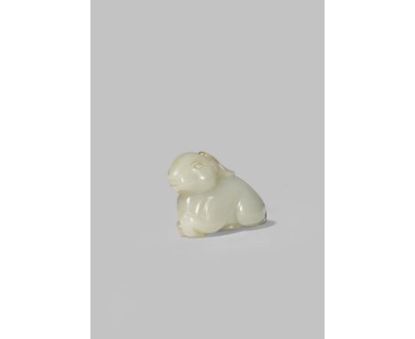 A CHINESE PALE CELADON JADE CARVING OF A DEER QING DYNASTY Recumbent with its legs tucked neatly beneath the body, 6.7cm.