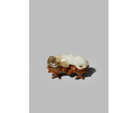 A CHINESE WHITE AND BROWN JADE CARVING OF TWO BADGERS 18TH CENTURY The cub carved from the brown side of the stone, the sow f