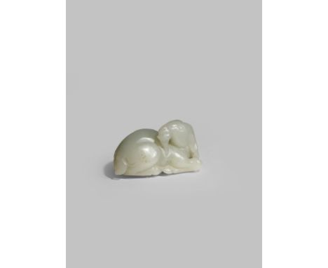 A CHINESE PALE CELADON JADE MODEL OF A GOAT LATE QING DYNASTY Recumbent with his head turned to the side, with long horns and