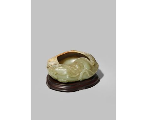 A CHINESE CELADON JADE BRUSH WASHER QING DYNASTY Carved as a large peach with a stem, leaves and smaller fruits issuing from 