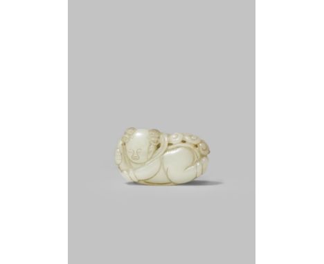 A CHINESE WHITE JADE CARVING OF A BOY QING DYNASTY Carved with his hair in two buns to the sides of his head, holding a leafy