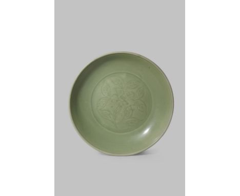 A LARGE CHINESE LONGQUAN CELADON DISH MING DYNASTY Carved to the centre with a single spray of camelia within an incised doub