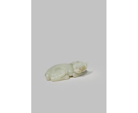 A CHINESE PALE CELADON JADE CARVING OF A QILIN 18TH CENTURY Reclining with its head turned to the side and a single horn, the