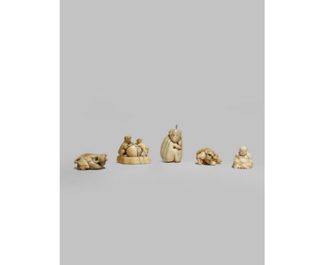 λ FOUR JAPANESE IVORY NETSUKE 18TH AND 19TH CENTURIES Variously carved as a reclining buffalo, two dogs playing with a large 