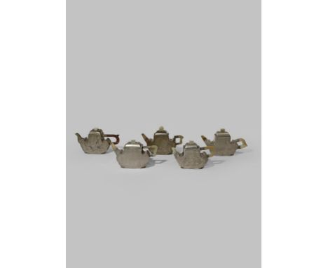 FIVE CHINESE INSCRIBED PEWTER-ENCASED YIXING TEAPOTS AND COVERS QING DYNASTY Each with a ruyi-head-shaped body, four set with