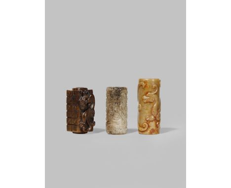 THREE CHINESE JADE CYLINDRICAL BEADS QING DYNASTY OR LATER One of brown stone in the form of a cong with a chilong dragon car