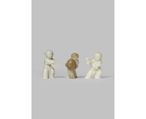 THREE CHINESE PALE CELADON JADE FIGURES OF CHILDREN QING DYNASTY OR LATER One carrying a large peach, another with rattles an