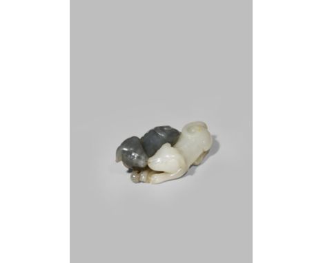 A CHINESE WHITE AND GREY JADE CARVING OF TWO HOUNDS QING DYNASTY Finely carved with the two dogs recumbent with their heads t