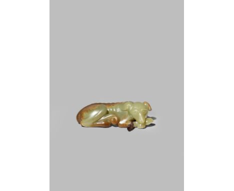 A CHINESE YELLOW-GREEN JADE CARVING OF A HOUND QING DYNASTY Recumbent with his body curved and his head turned to dexter rest
