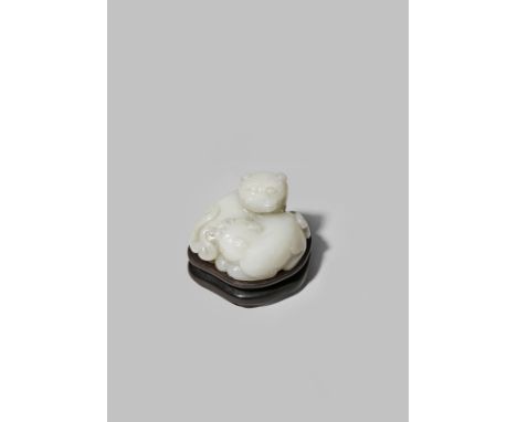 A CHINESE WHITE JADE CARVING OF TWO LION DOG PUPPIES QING DYNASTY Recumbent, huddled together and turning their heads towards