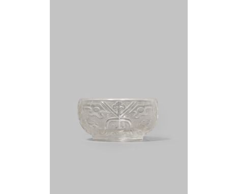 A CHINESE ROCK CRYSTAL ARCHAISTIC BOWL QING DYNASTY The compressed circular body carved with taotie masks and dragon heads on