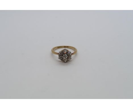 An 18ct yellow gold (hallmarked) diamond daisy cluster ring set with old mine cut diamonds, size K, approx 2.9 grams 