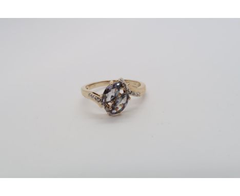 A 9ct yellow gold double marquise cut lilac tourmaline and diamond ring size P/Q 