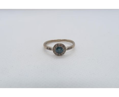 A 14ct white gold (hallmarked) blue diamond ring - the central round brilliant cut blue diamond approx 0.3ct set with halo of