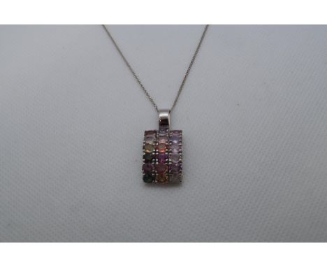 A 9ct white gold (hallmarked) pendant with coloured stones - 3cm (in ring) approx weight 5 grams - on a silver chain 