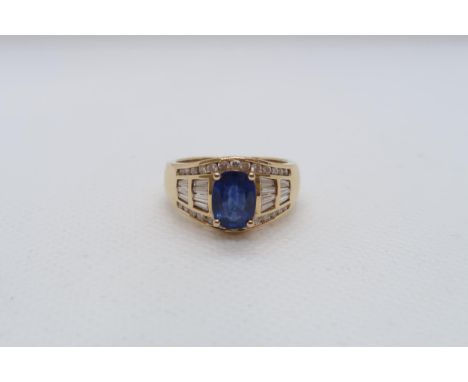 A good sapphire and diamond ring - The central oval sapphire approx 8mmm x 6mm with 14 baguette cut diamonds and 26 graduated