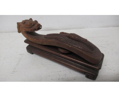 A brown Jade Ruyi Sceptre on a wooden stand - Width 12cm 