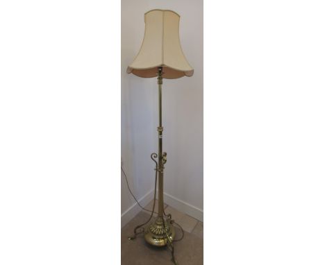 A good quality brass lamp with adjustable height on three outswept legs, 190cm high 