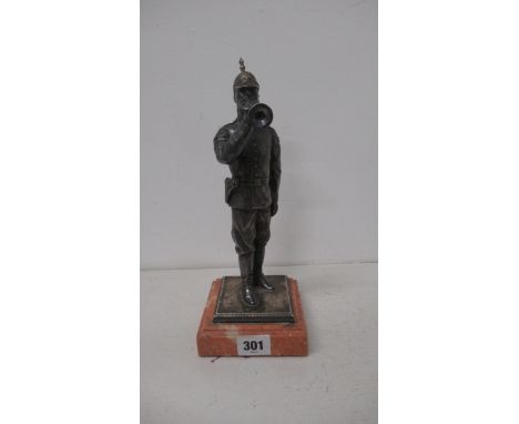 A silver (tested) figure of a soldier with bugle on stone base - 27cm 