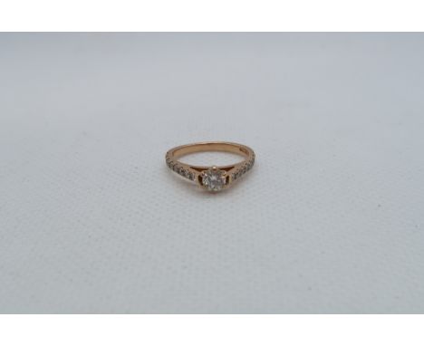 An 18ct rose gold (hallmarked) diamond solitaire ring - The central diamond approx 0.2ct and set with diamond accent shoulder