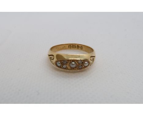 An 18ct (hallmarked) yellow gold ring with pearls and diamond accent - ring size N/O - weight approx 4.5 grams 