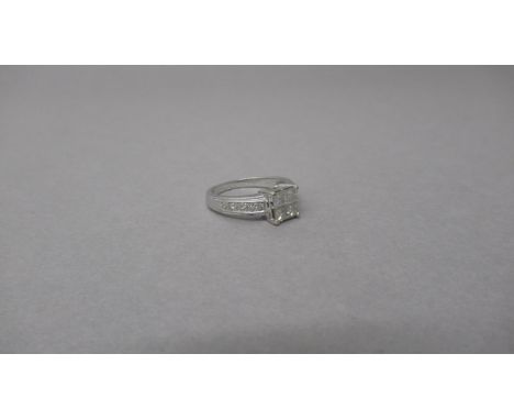 An 18ct white gold and diamond ring - Four central square cut diamonds each approx 0.15-0.2ct - shoulders set with four round