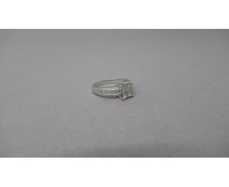 An 18ct white gold and diamond ring - Four central square cut diamonds each approx 0.15-0.2ct - shoulders set with four round