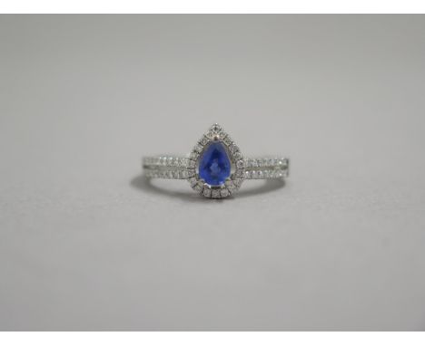 An 18ct white gold pear shaped sapphire and diamond ring, diamonds are well matched and bright and lively - head size approx 