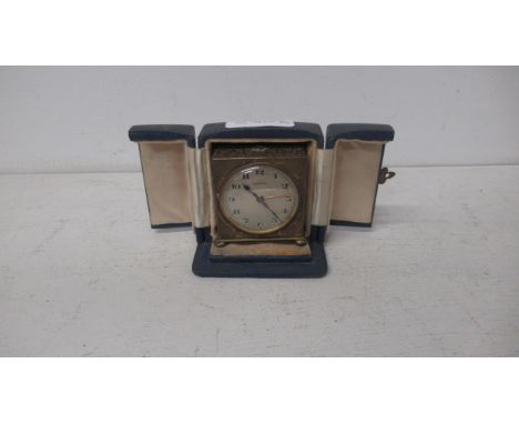 A Zenith travelling miniature alarm clock - approx 5cm x 5.5cm - in original case - not currently working 