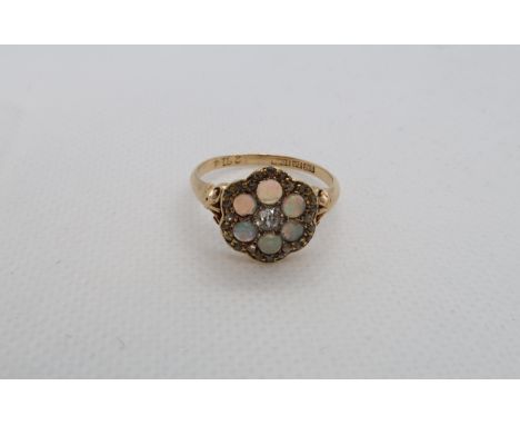 An 18ct (hallmarked) yellow gold diamond and opal daisy cluster ring size R/S - weight approx 3.6 grams - one opal chipped 