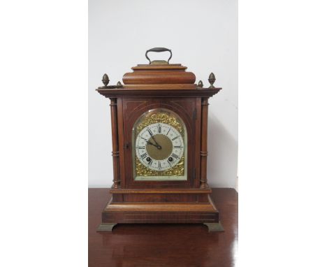 A Lenzkirch mahogany architectural 8 day mantel clock with brass dial on four brass feet with carry handle, 46cm x 29cm x 20c