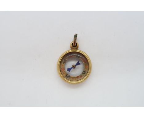 An approx 18ct (tested) fob / charm as a compass, 1.8cm, approx 5.4 grams 